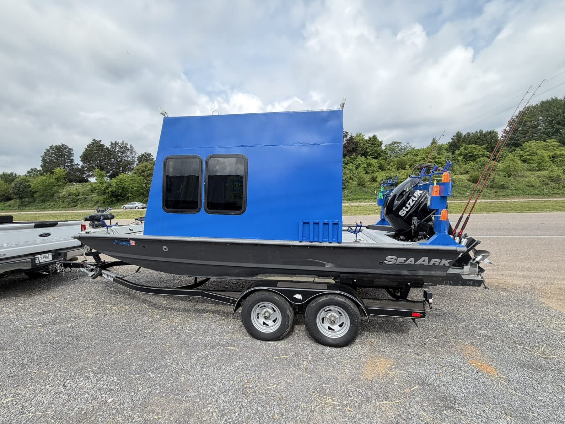 The boat a seaark with a full blue cabin